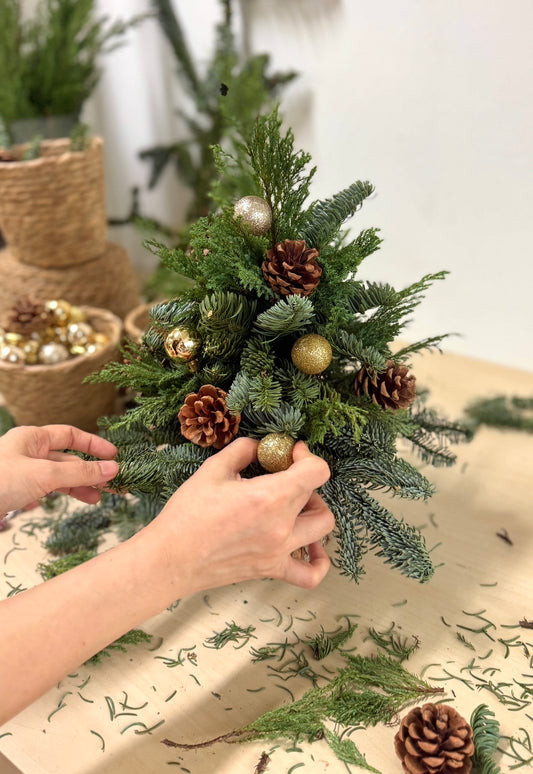 Decorating a fresh tabletop Christmas tree