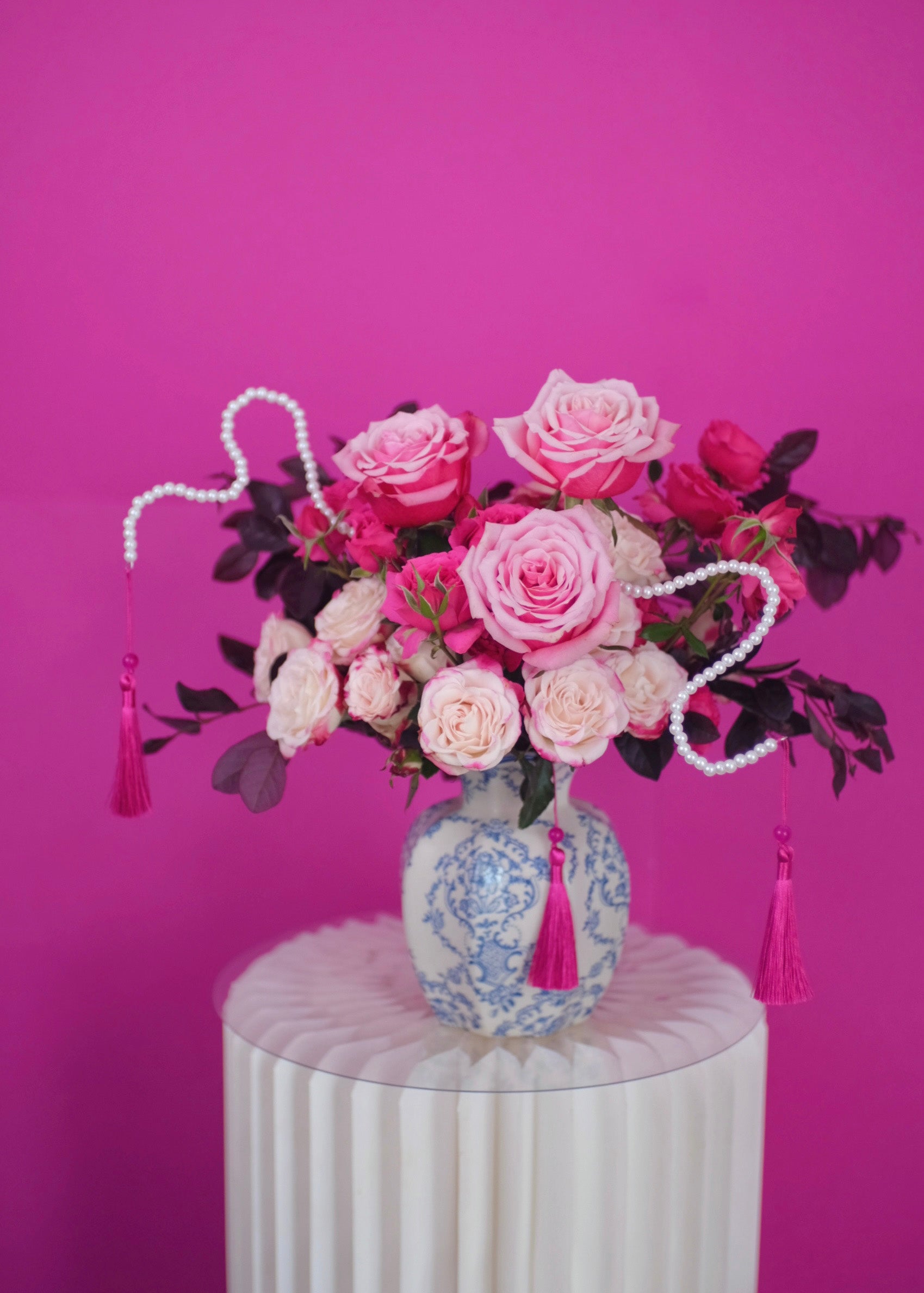 CNY floral arrangement features year of snakes blessings roses and snake-like pearls in china vase