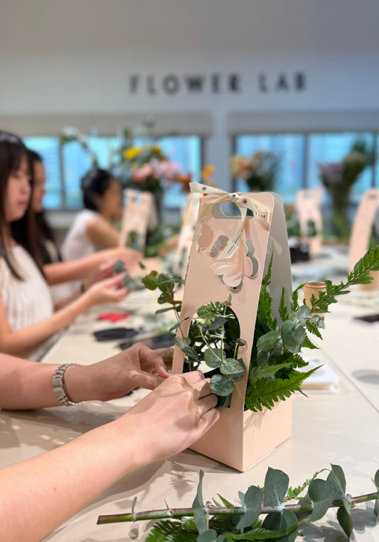 People working on floral arrangements in a 'Flower Lab' setting, Fresh Floral Workshop Singa