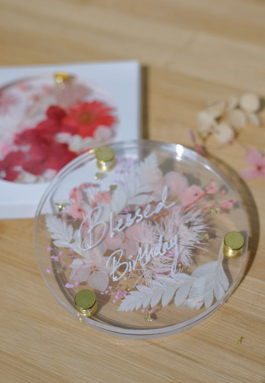 Decorative acrylic coaster with floral design and 'Blessed Birthday' text. 