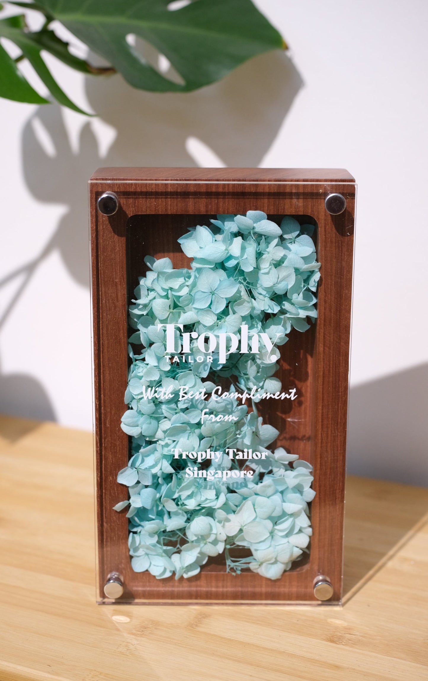 Decorative box trophy with turquoise floral on a wooden surface