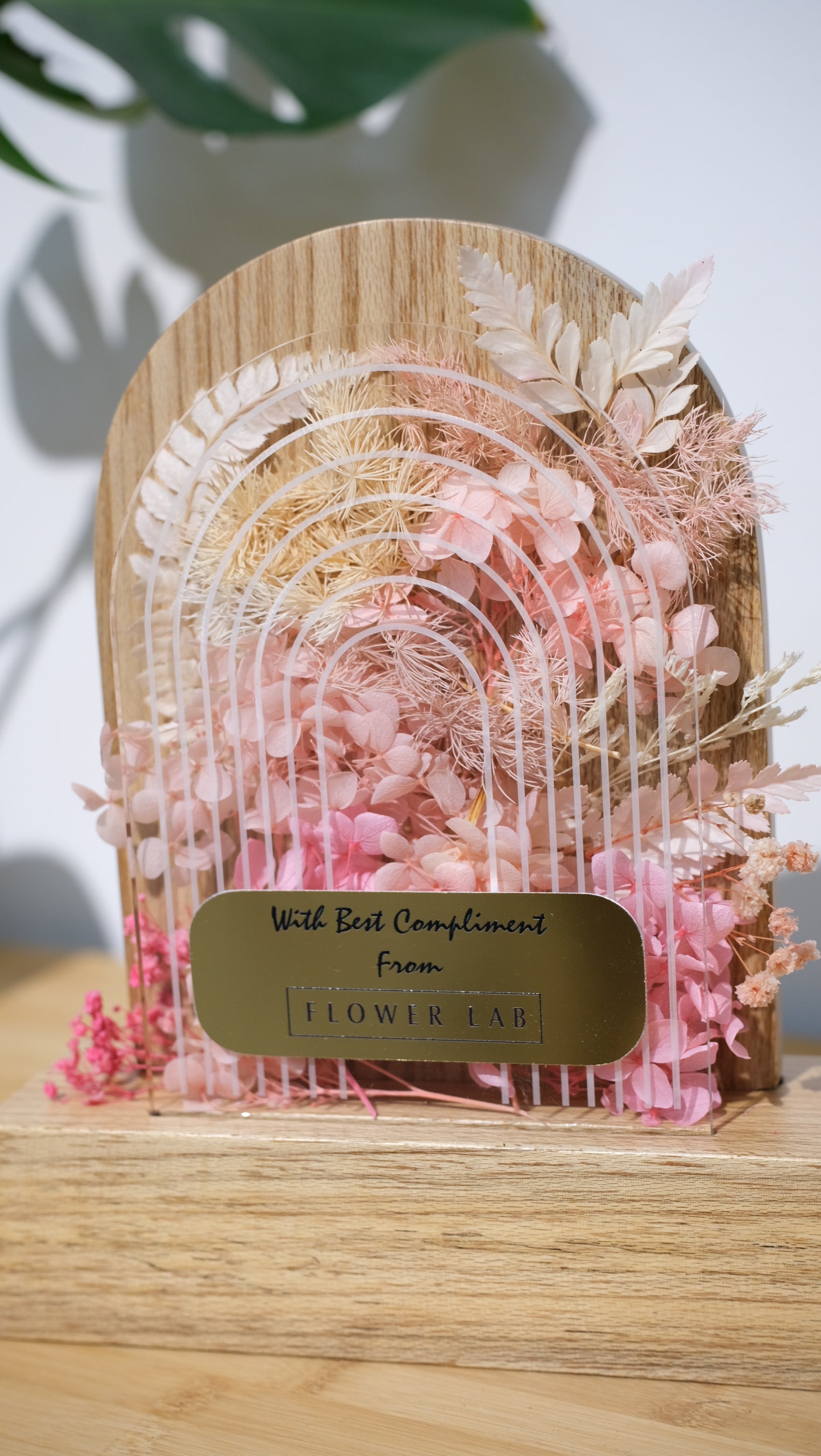 Decorative box trophy award with floral design and 'Flower Box' label on a wooden surface.