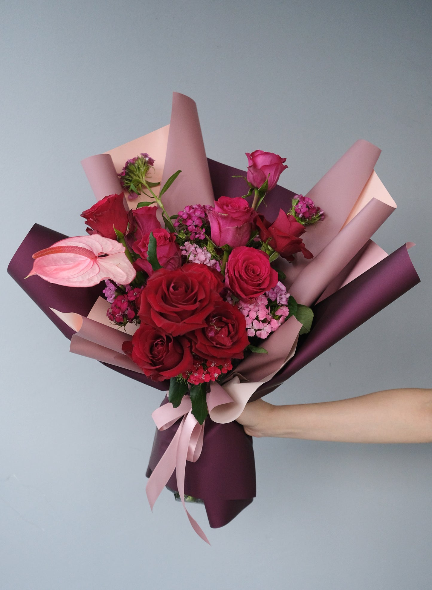 red and hot pink roses bouquet with anthuriums